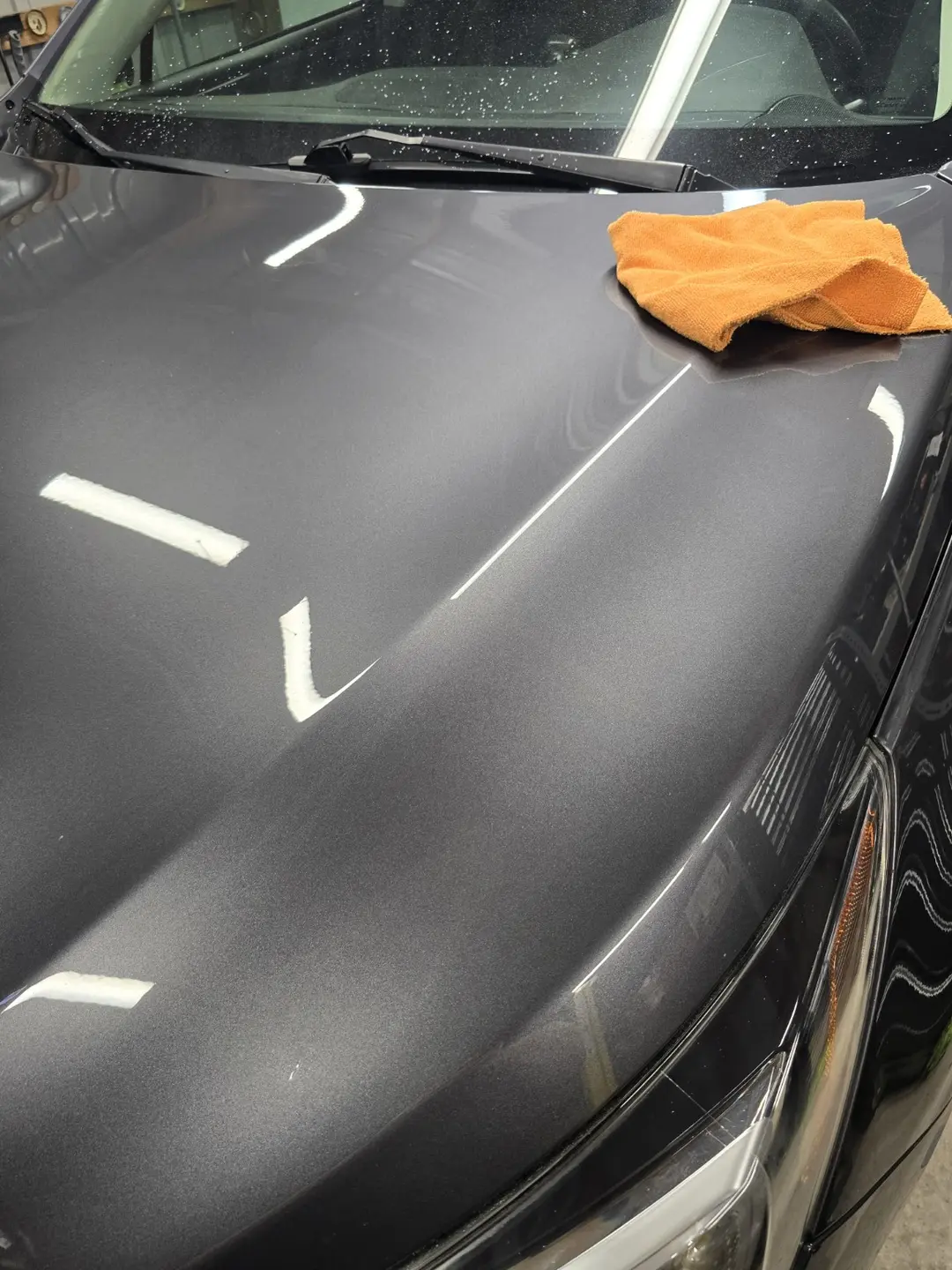 Reflection clarity developing on the Subaru Outback hood during polishing
