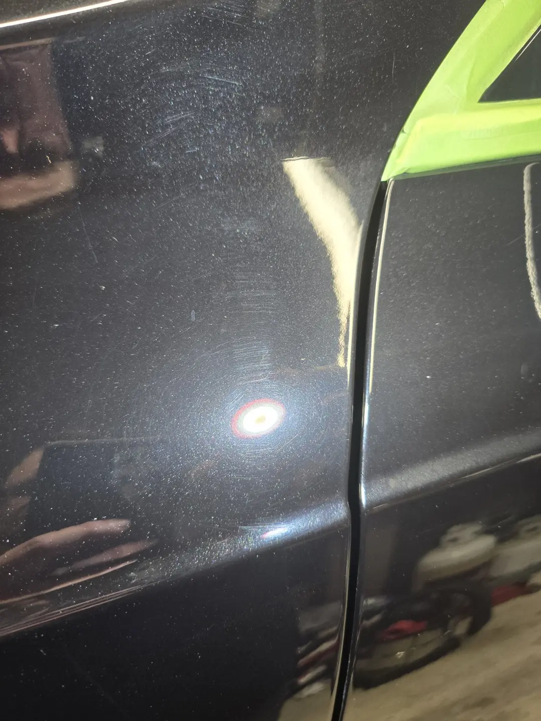 Fine scratches and marring near an XC90 panel edge before correction